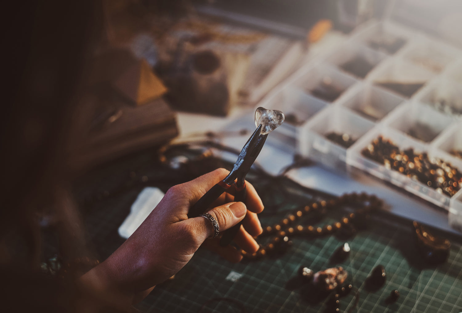 Deja Veux jeweler working on rings, earrings, necklaces and bracelets with 925 silver and natural gemstones